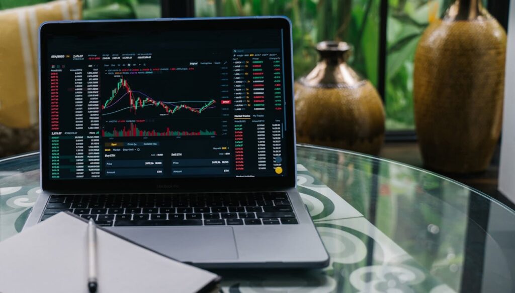 Cryptocurrency trading chart displayed on a laptop, showing market trends and price fluctuations for crypto investments.